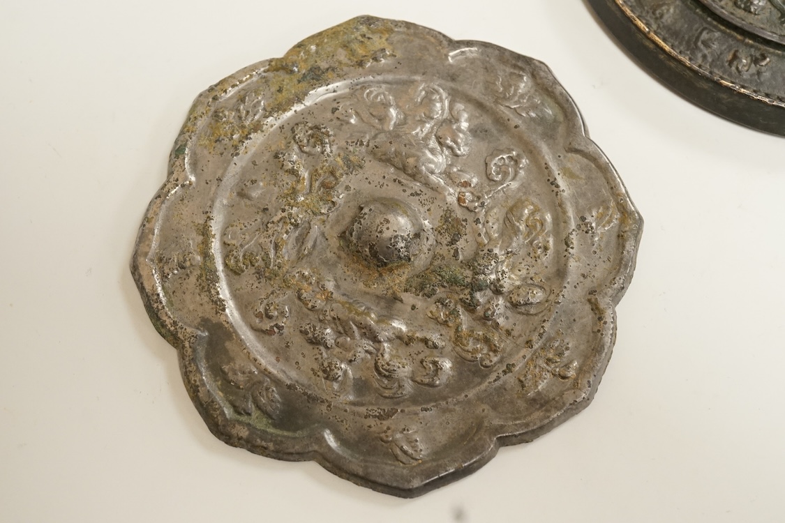 Two Chinese metal hand-mirrors, largest 13cm